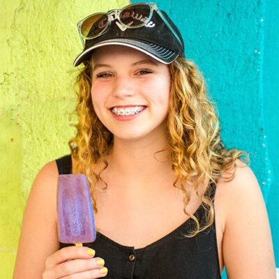 A teenage girl smiling with braces